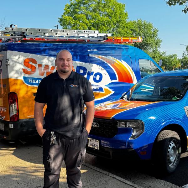 SwiftPro technician standing beside company van, providing AC replacement services in Northern Virginia.