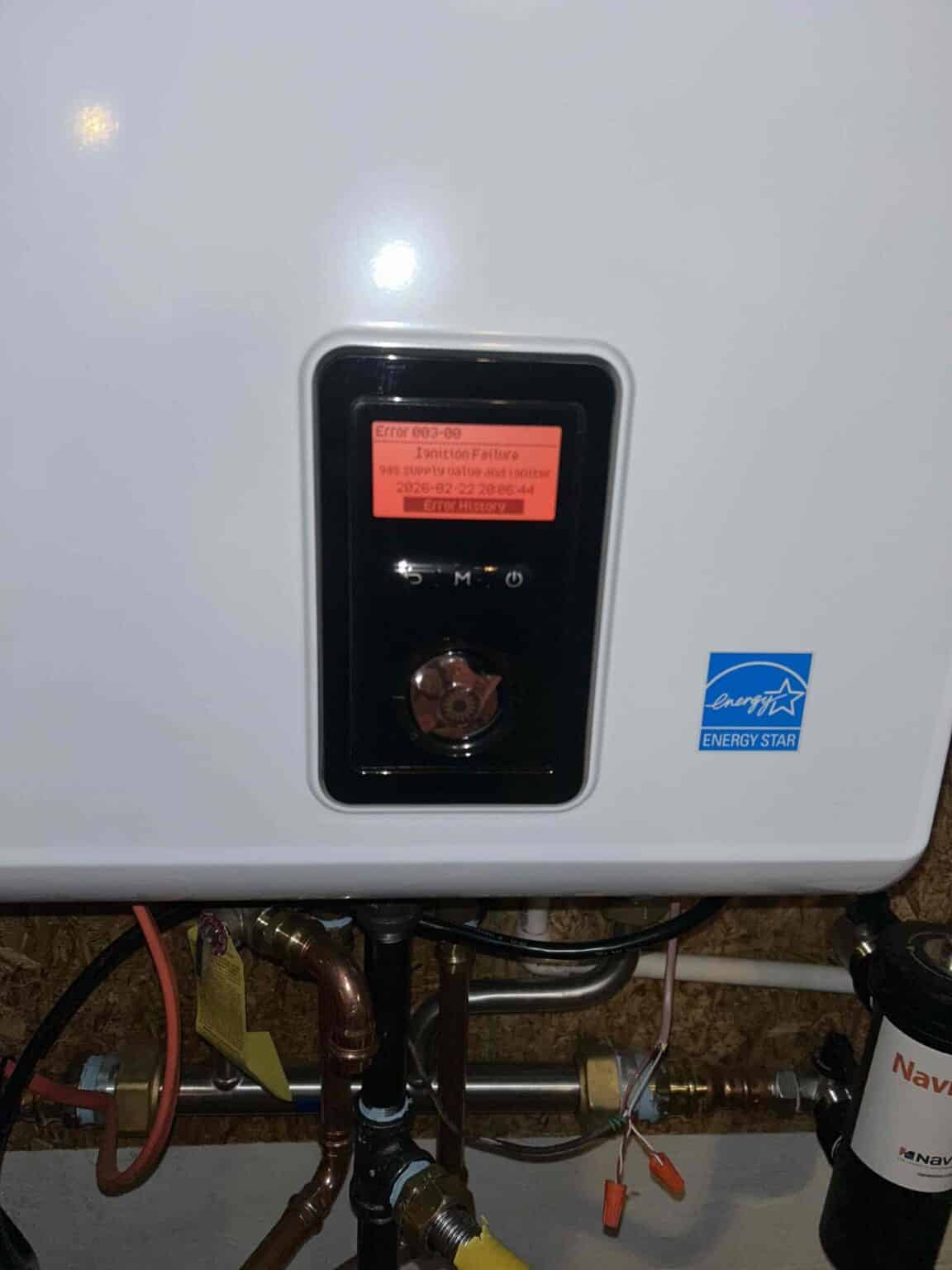 A Navien tankless water heater display showing Error 003-00, ignition failure, in a Northern Virginia home
