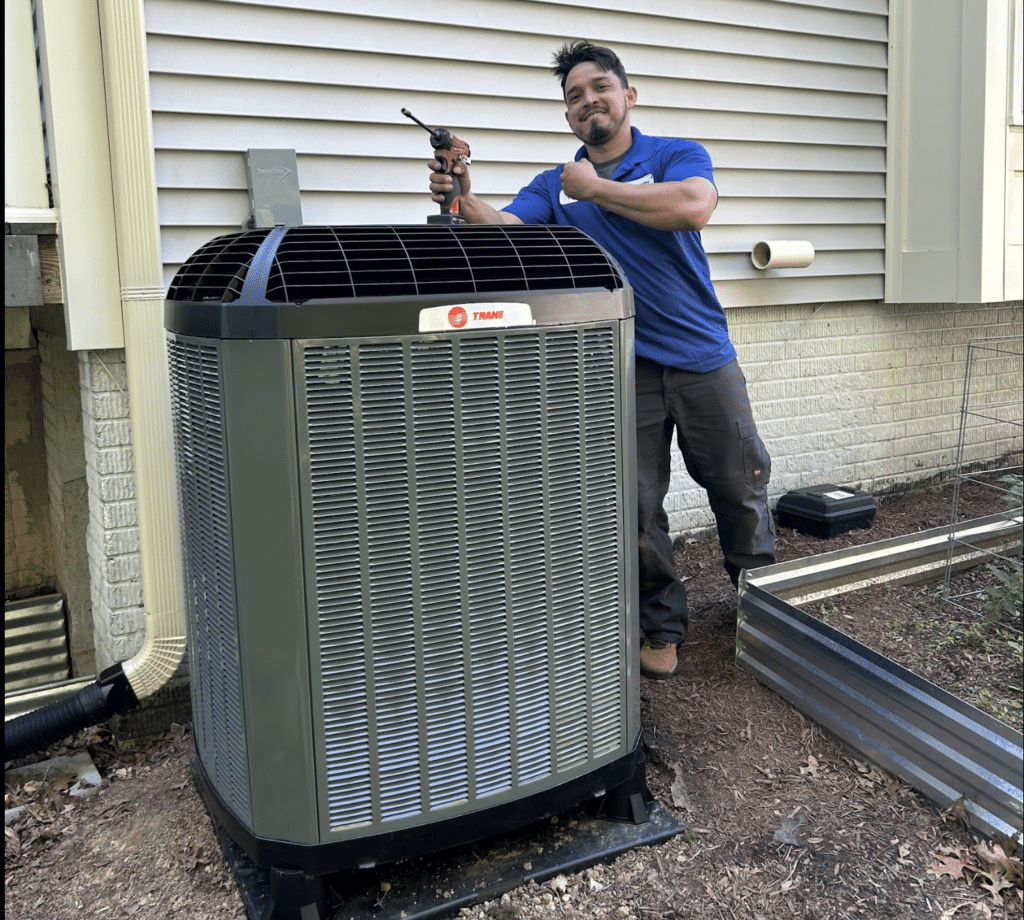 SwiftPro technician installing Trane air conditioning unit in Northern Virginia home.