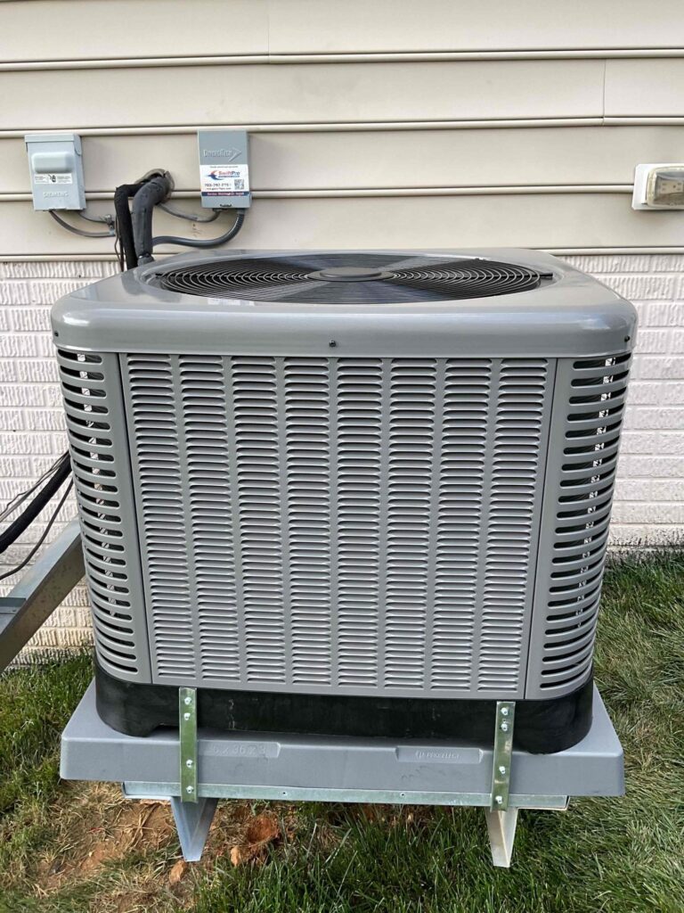 A large two-fan condensing unit mounted on wall brackets at a Northern Virginia home.