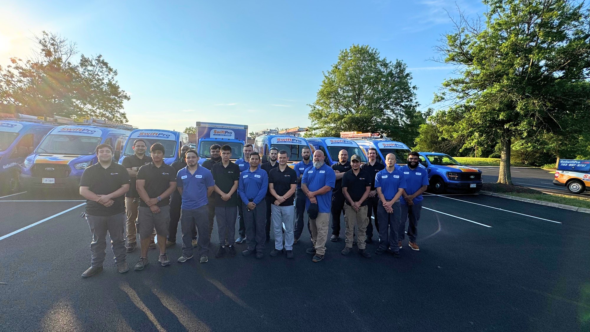 The full SwiftPro crew in front of the van fleet that serves Ashburn and Loudoun County, VA