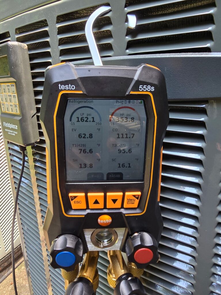 Digital manifold gauges hooked to a condenser in Northern Virginia showing pressure and temperature.