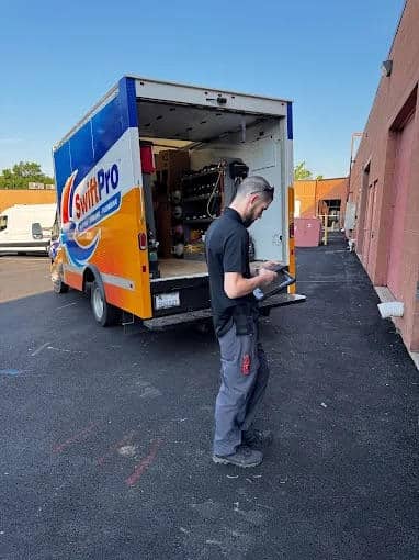 Contractor discussing emergency plumbing repair costs with homeowners