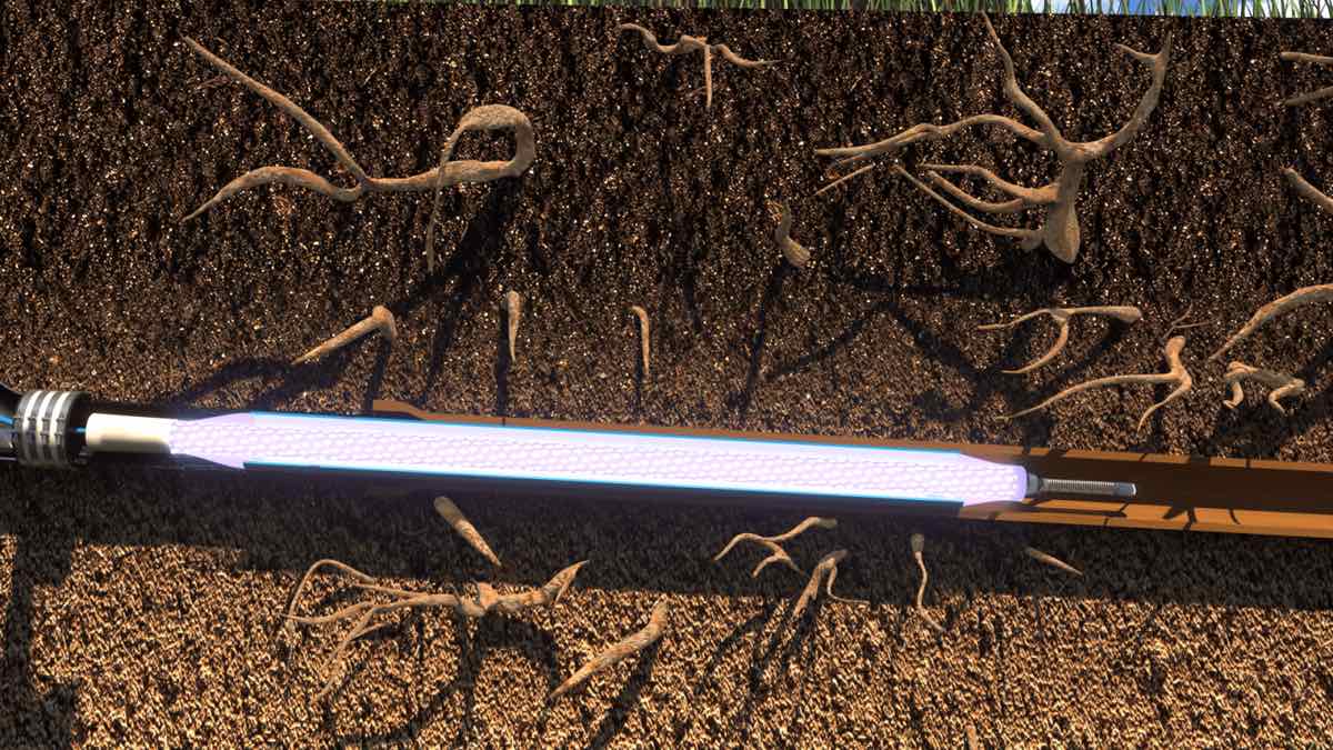 Cutaway illustration of an ultraviolet light train curing a resin-impregnated liner inside a buried sewer pipe, the trenchless repair that avoids digging up the yard