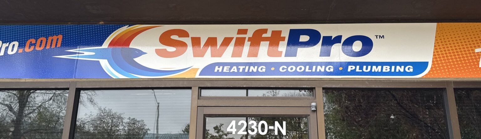 The SwiftPro Heating, Cooling and Plumbing sign over the door of the shop at 4230-N Lafayette Center Drive in Chantilly, Virginia