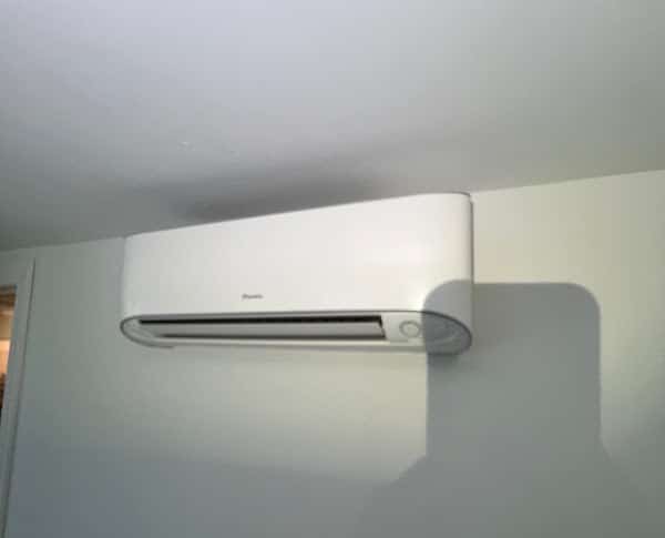 A wall-mounted ductless mini split indoor head high on an interior wall of a Northern Virginia home, on a SwiftPro job