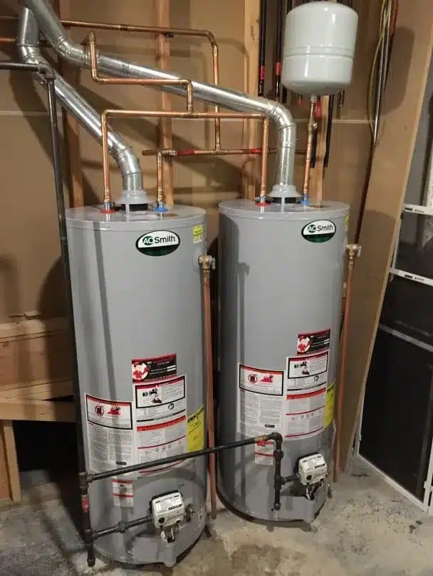 Two A.O. Smith gas water heaters and an expansion tank installed side by side by SwiftPro in a Northern Virginia utility room