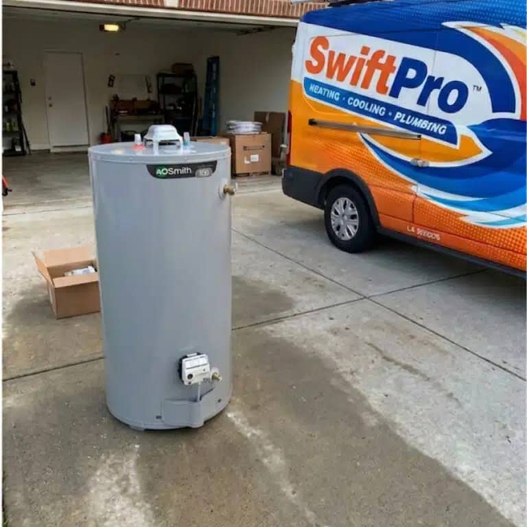 A new A.O. Smith gas water heater on a Northern Virginia driveway beside a SwiftPro van, ready to be installed