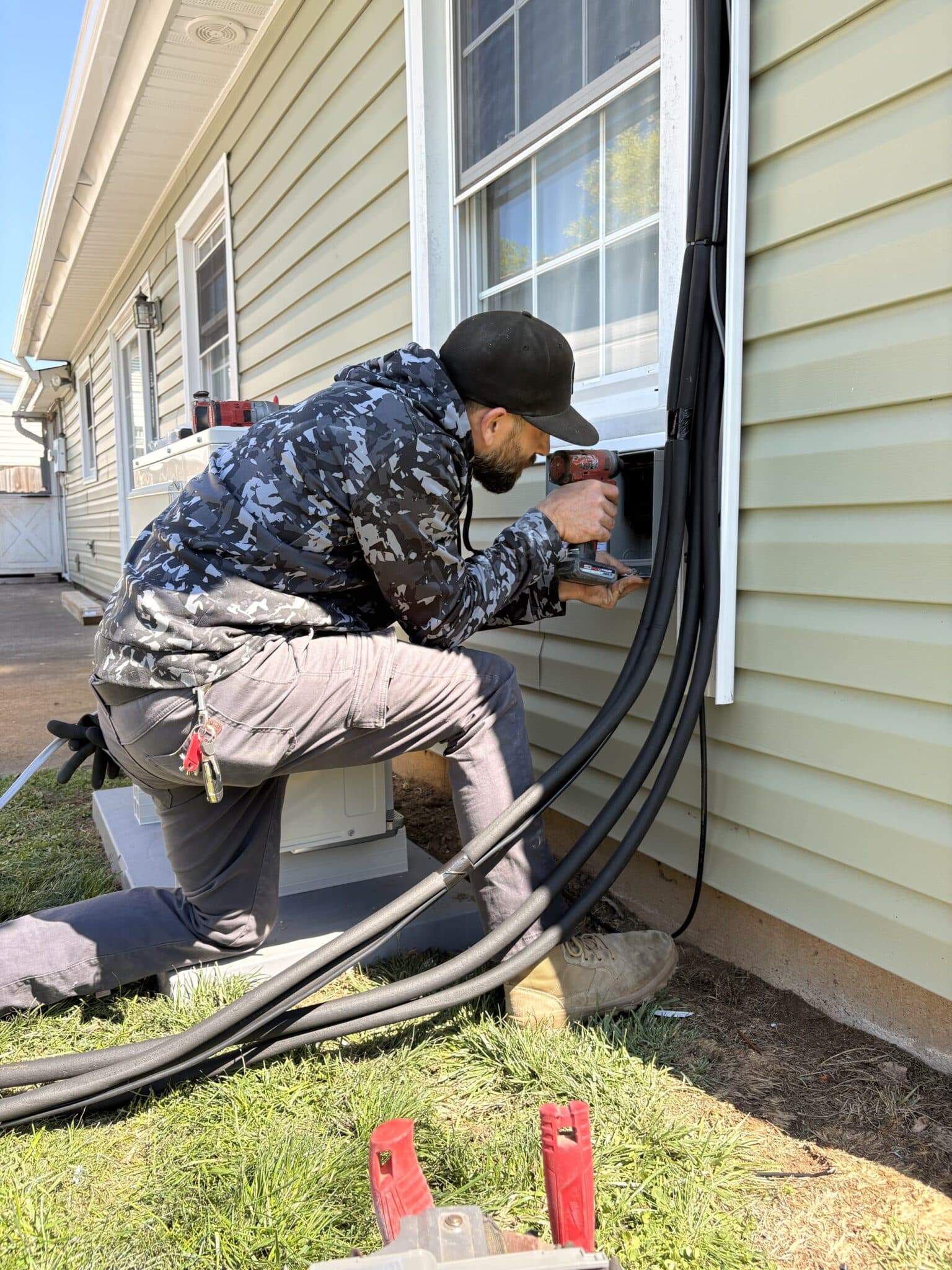 SwiftPro technician working on outdoor HVAC equipment beside a Northern Virginia home