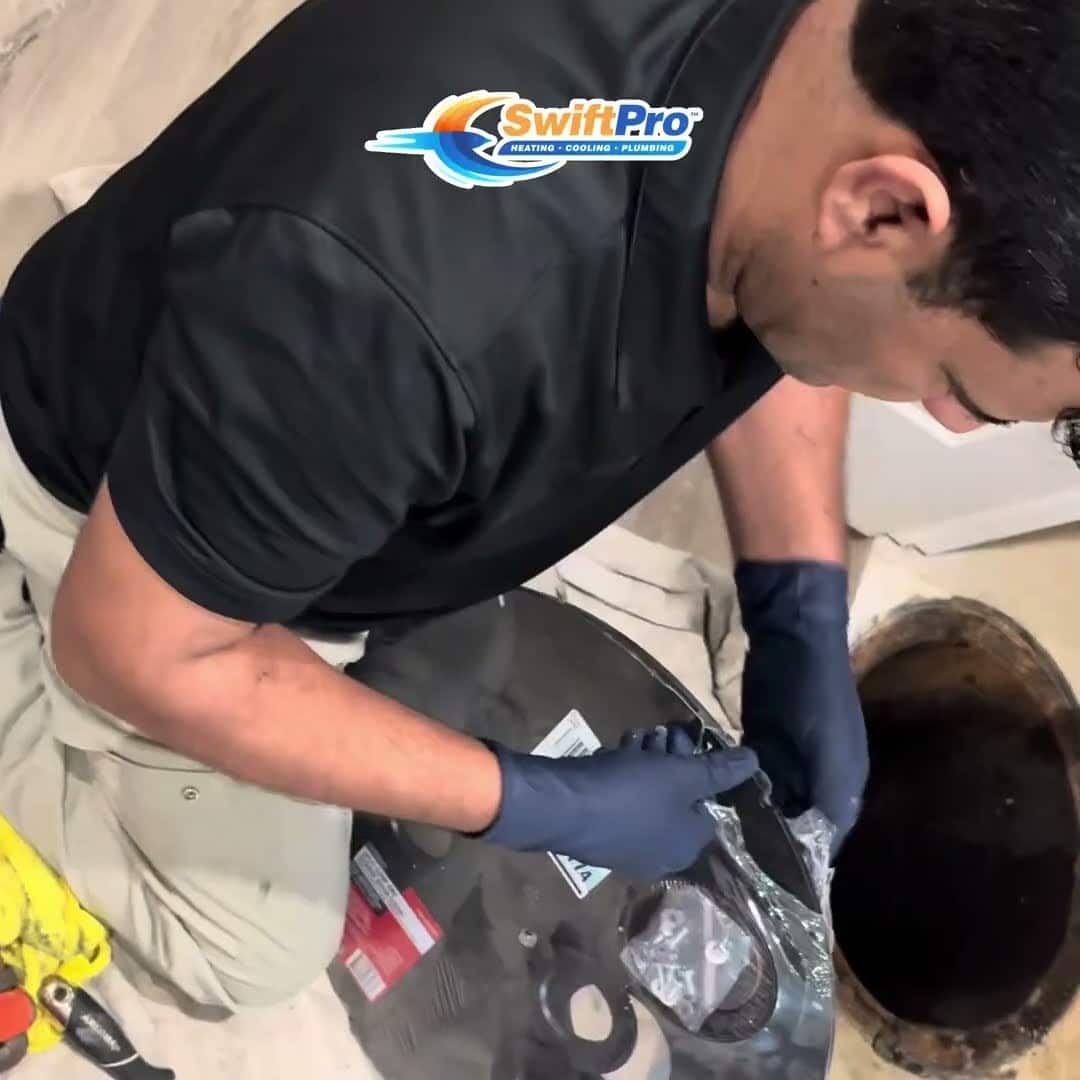 SwiftPro plumber unpacking the new sump pump beside the open pit in a Northern Virginia basement