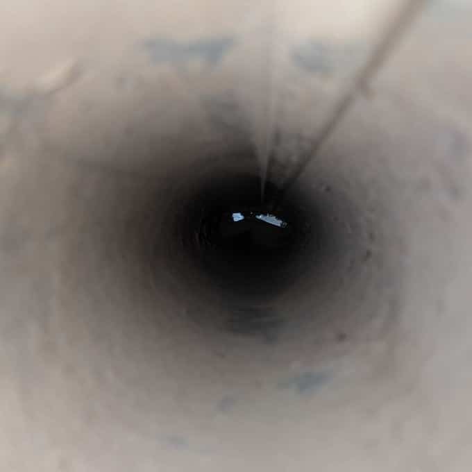 The same Ashburn, Virginia dryer vent line after a SwiftPro dryer vent cleaning: clean metal walls down to a clear opening