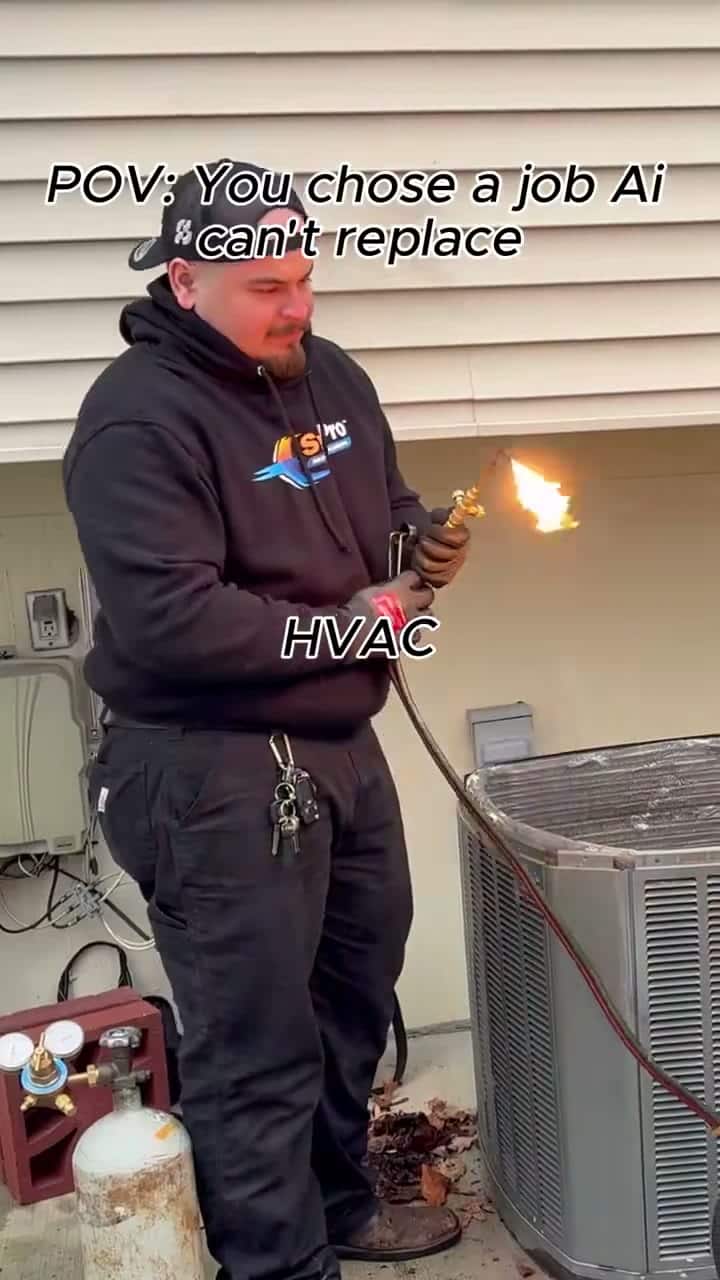 Montage captioned "POV: You chose a job AI can't replace / HVAC": a tech brazes a new compressor into a condenser, techs set and wire a new gas furnace in a garage, and a masked tech runs a duct-clean