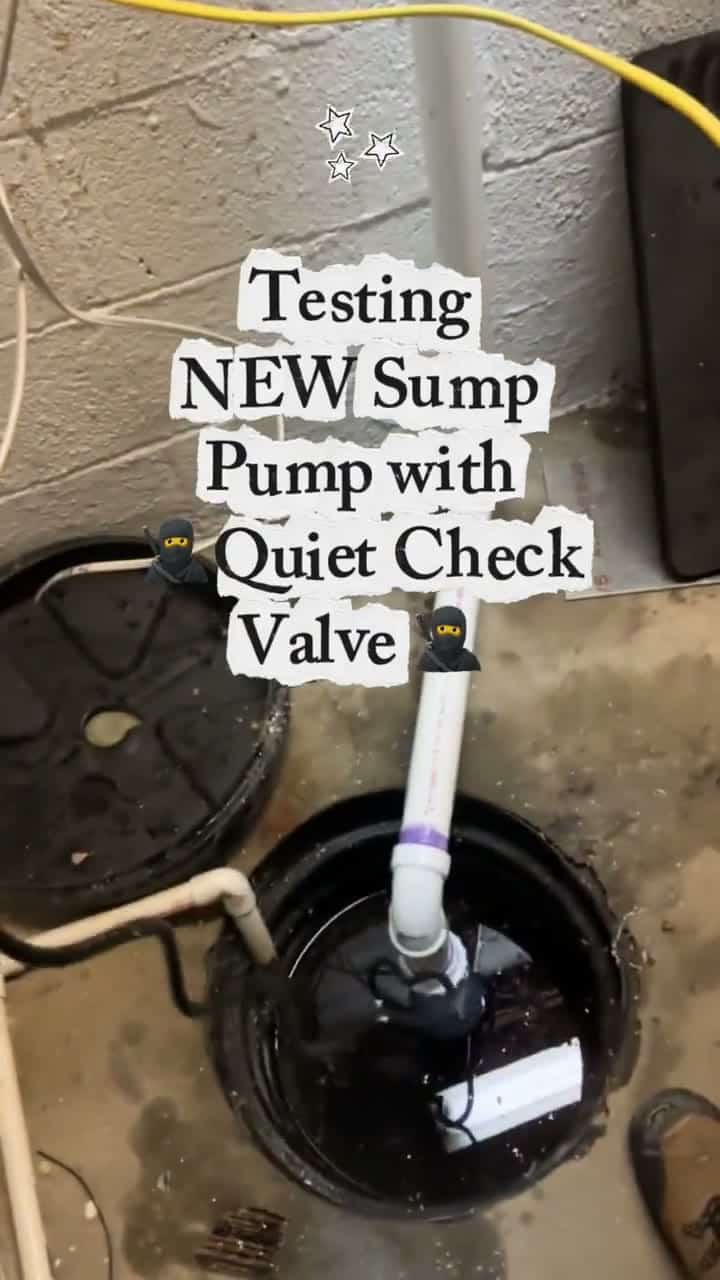 A new sump pump in a basement pit with a clear "The Quiet Check Valve" on the discharge pipe, captioned "Testing NEW Sump Pump with Quiet Check Valve".
