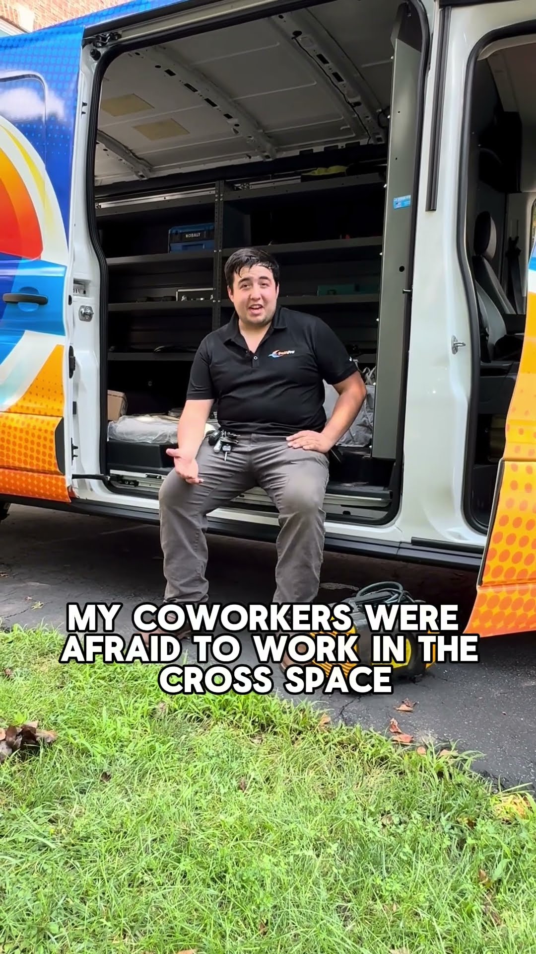 A tech in a black SwiftPro polo sits on the rear step of an open SwiftPro van (shelving inside, yellow fan on the grass) and answers 'What's the weirdest thing you have found?', a crawl space animal s