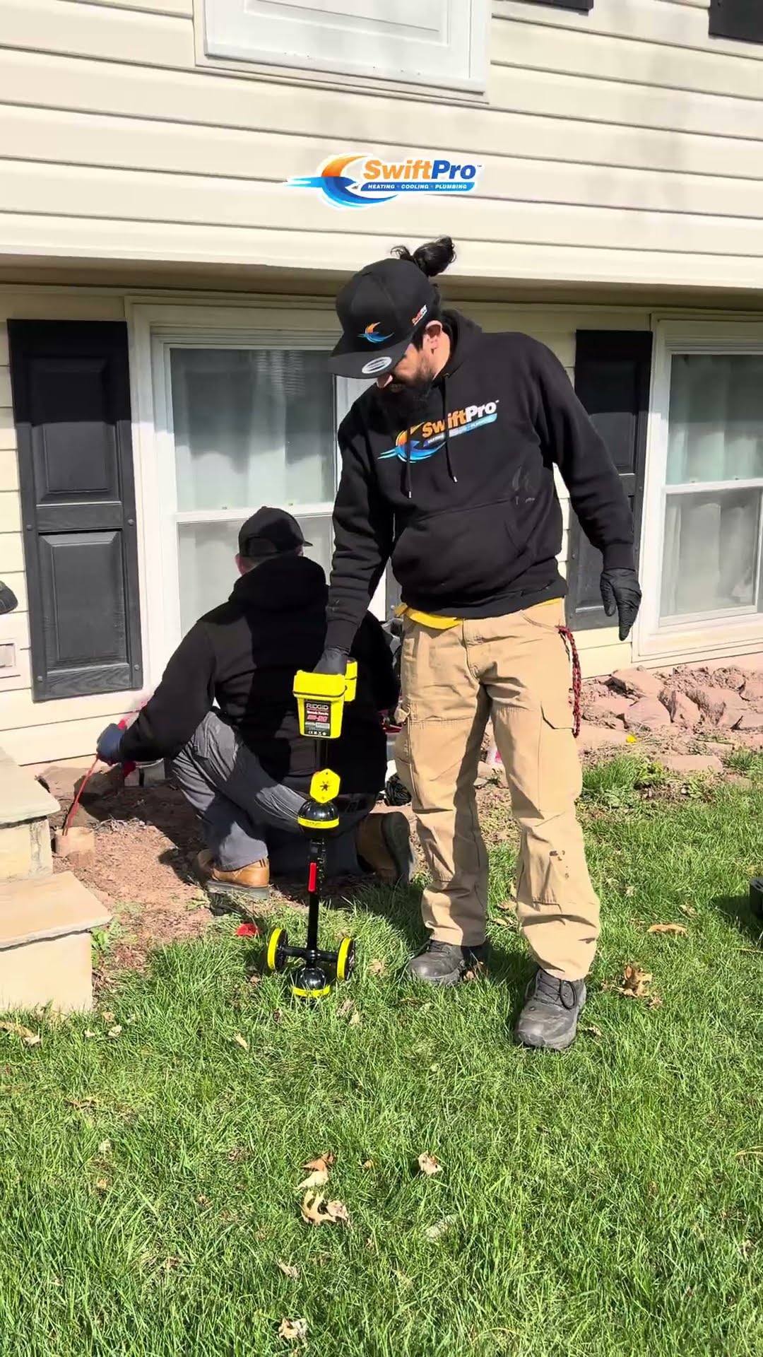 HVAC tool montage: a tech in a black SwiftPro hoodie stands beside a yellow wheeled tool in a front yard while another tech kneels at the house, a tech uses a clamp meter inside an air handler control