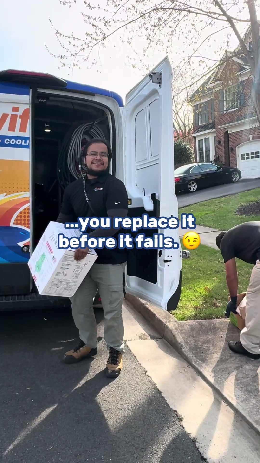A bucket of sludge from an old sump pit, a tech in glasses and a black SwiftPro hoodie carrying a boxed new sump pump from the SwiftPro van in a brick-house neighborhood, and the finished pit with a s