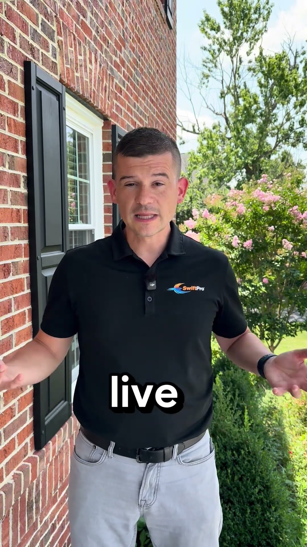 A man in a black SwiftPro polo stands against a brick house wall by crepe myrtles and talks about what a local family business means, with a cutaway of the wrapped SwiftPro van.
