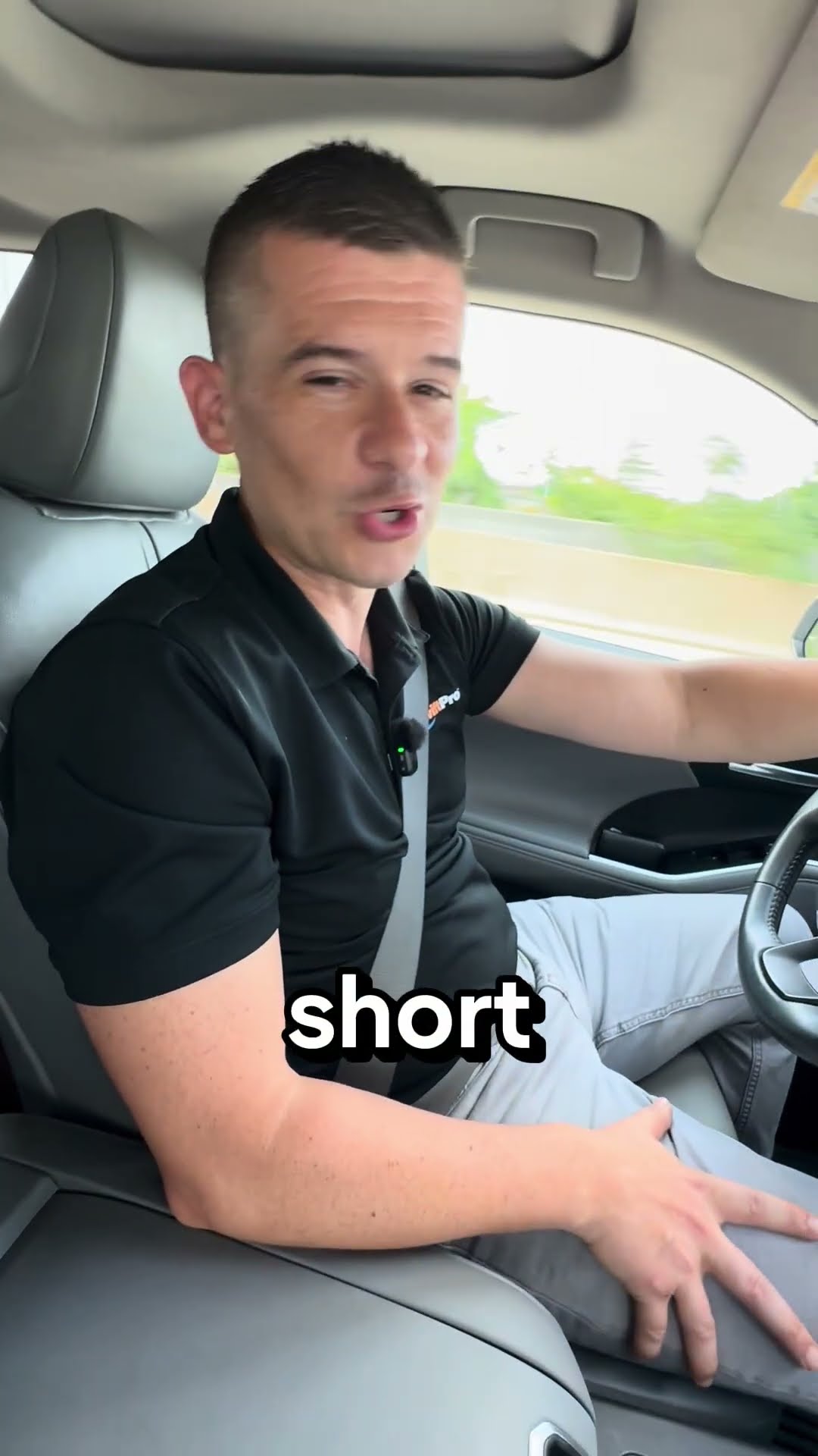 A man in a black SwiftPro polo talks to camera from the front seat of a moving car about SwiftPro being a local, family-owned Northern Virginia company.