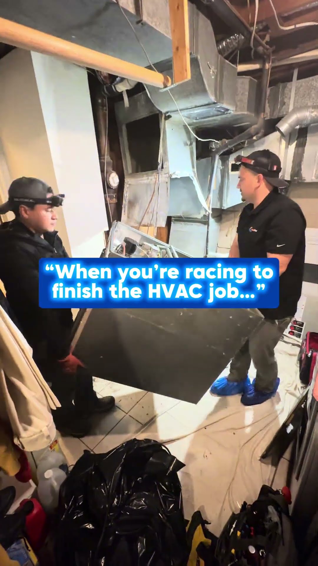 Skit in a basement furnace room: two techs in shoe covers carry out old furnace panels, one poses to camera, and a tech crouches at a newly installed gas furnace.