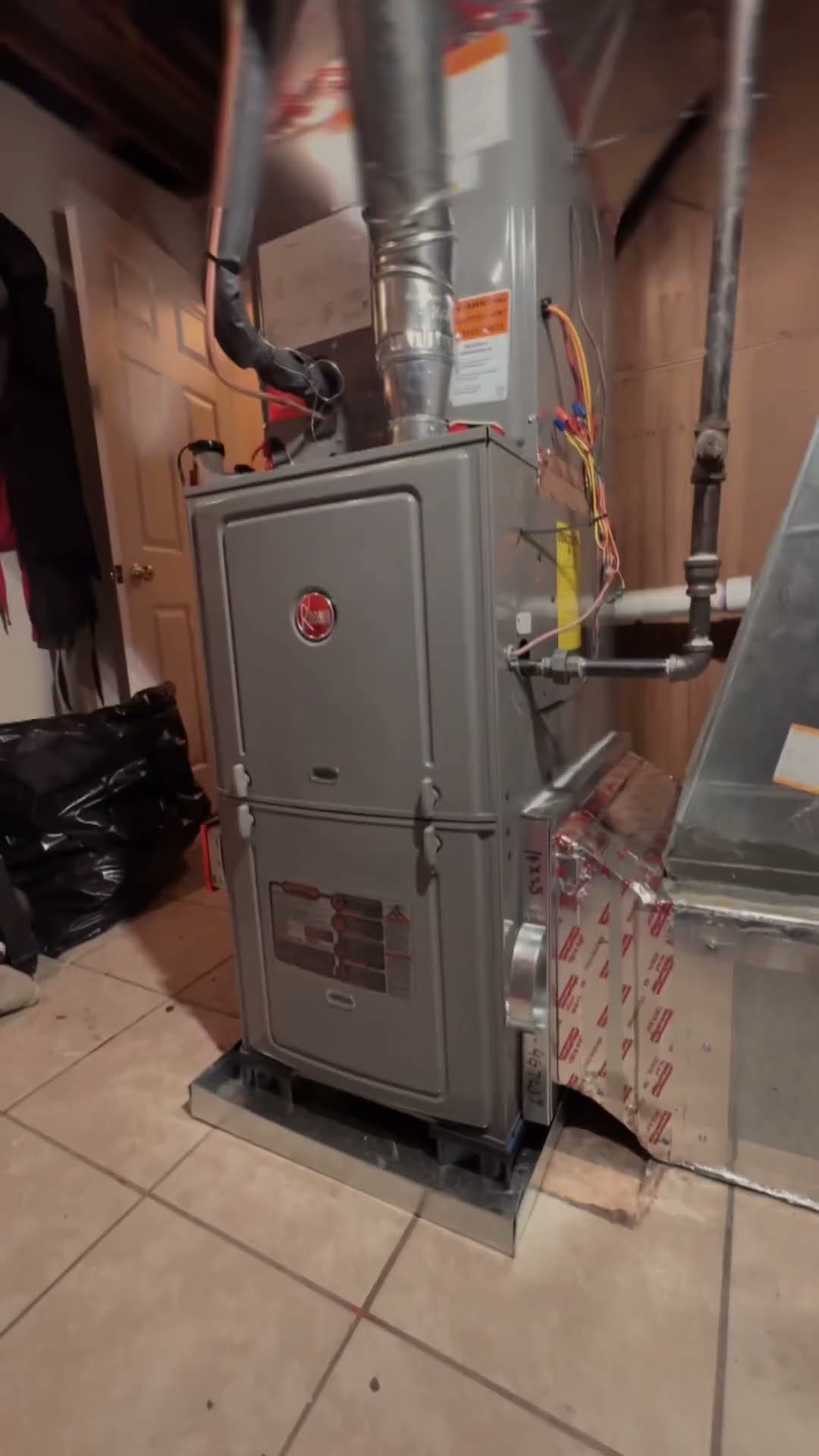 Opens on a meme clip of a stranger in a maroon hoodie walking down a city street ('what is bro filming'), then a new Rheem furnace (Rheem logo legible) installed in a basement with new plenum.