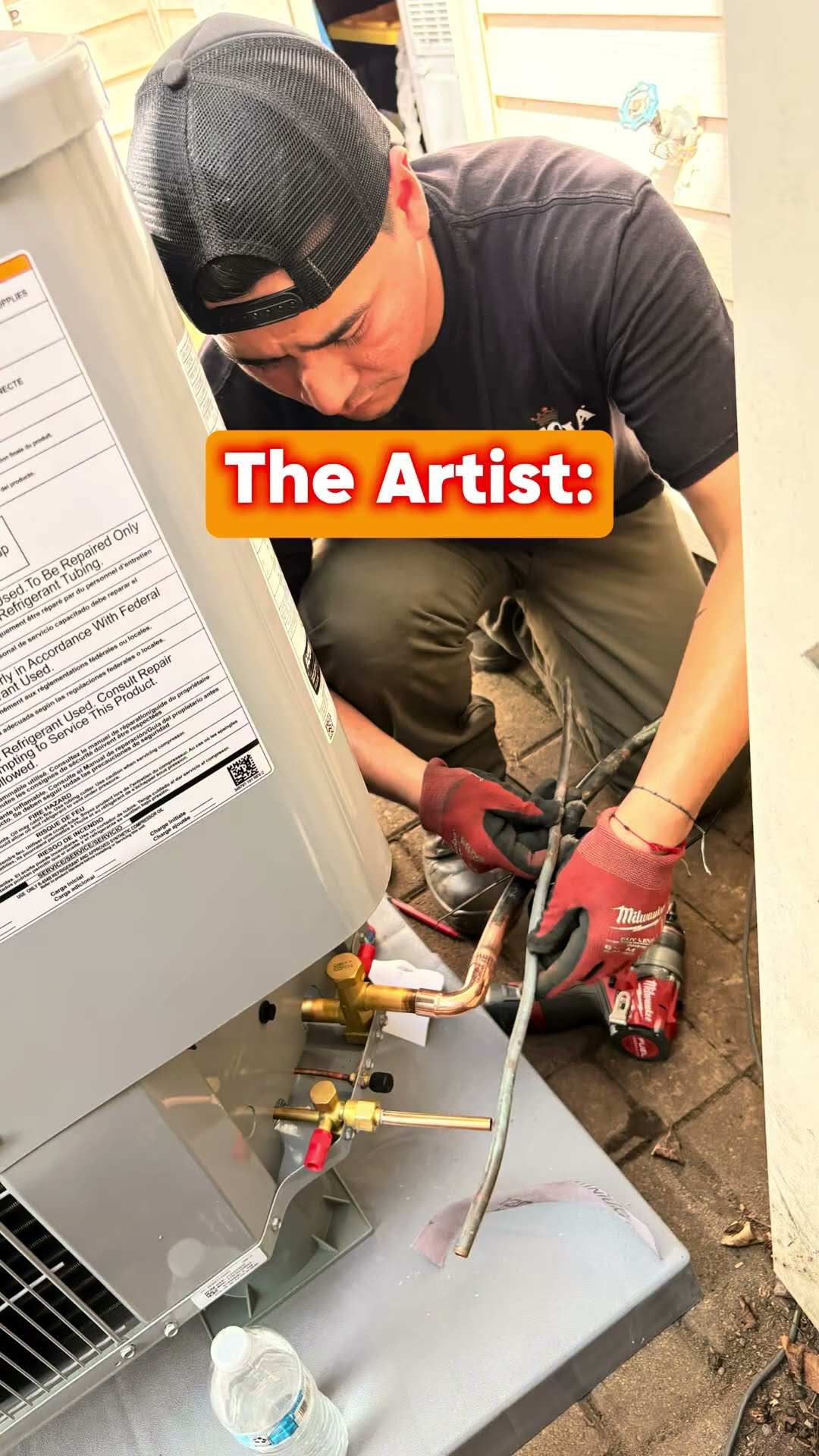 Meme format: a tech in a backward black cap and Milwaukee gloves connects the line set at the service valves of a new Carrier condenser on a brick paver patio, then the finished Carrier unit on its pa