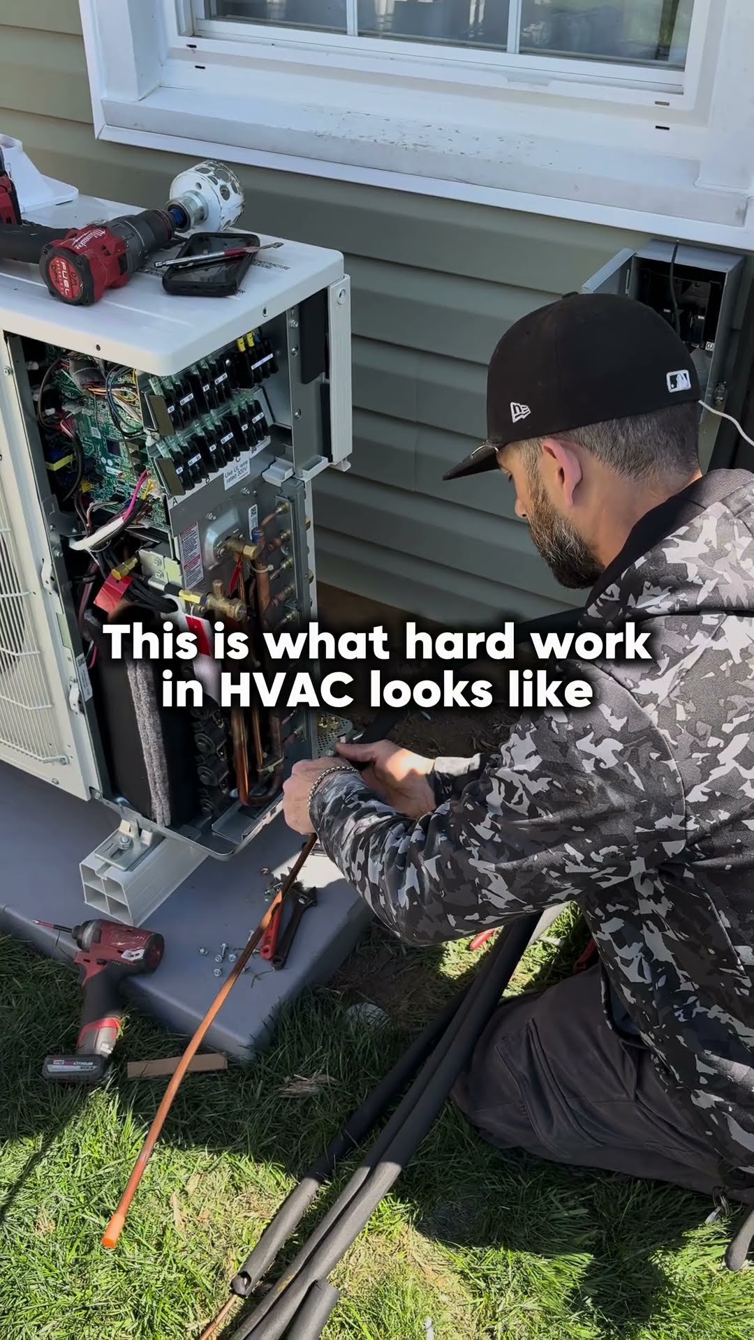 Motivational caption over job footage: a bearded tech in a camo jacket wires an opened mini-split outdoor unit, two techs dig a deep hole in a suburban front yard with a digging bar and shovel, and a