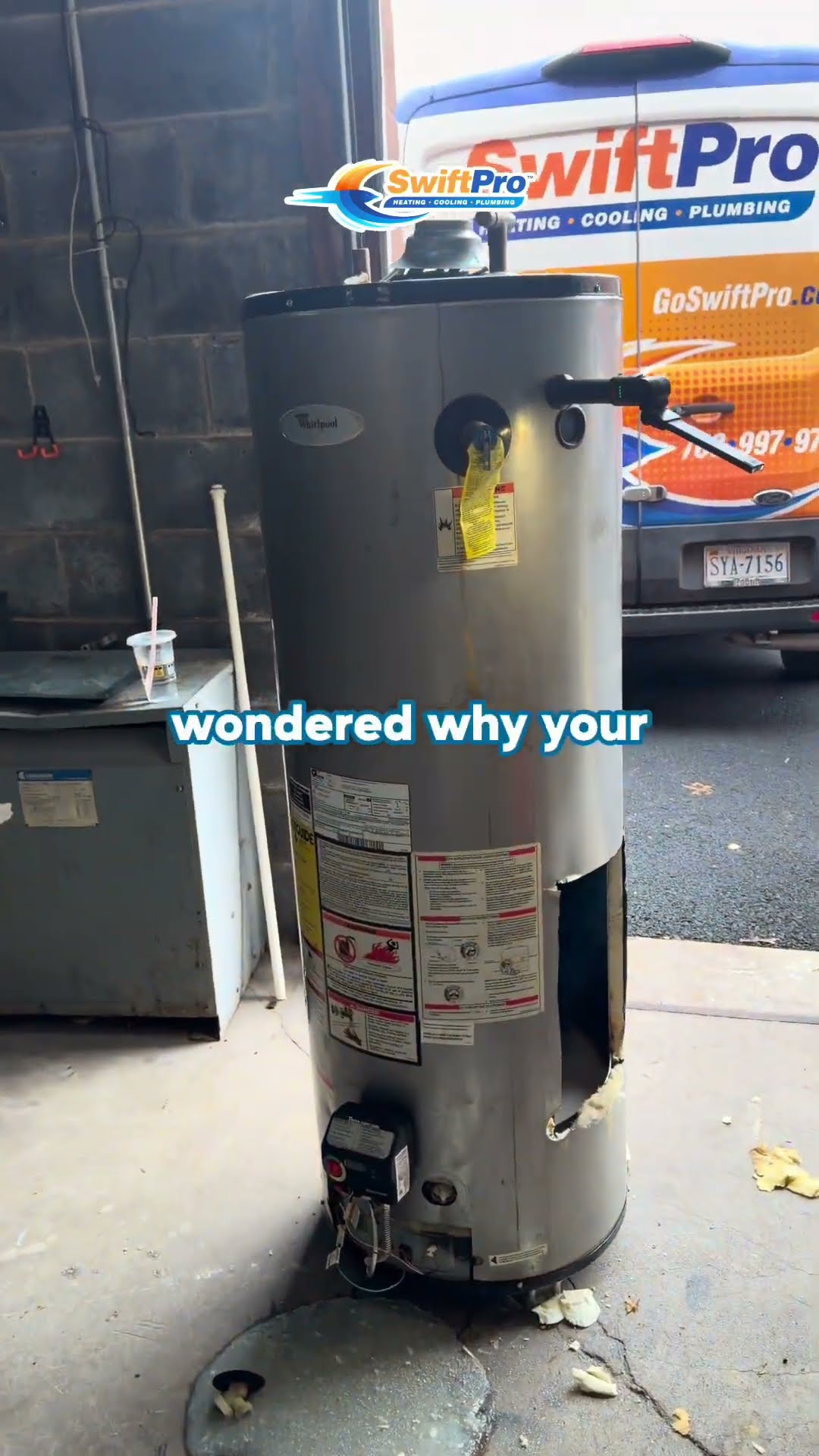An old Whirlpool gas water heater (Whirlpool logo legible) is cut open by a tech in safety glasses beside a SwiftPro van at the shop, revealing the corroded inside.