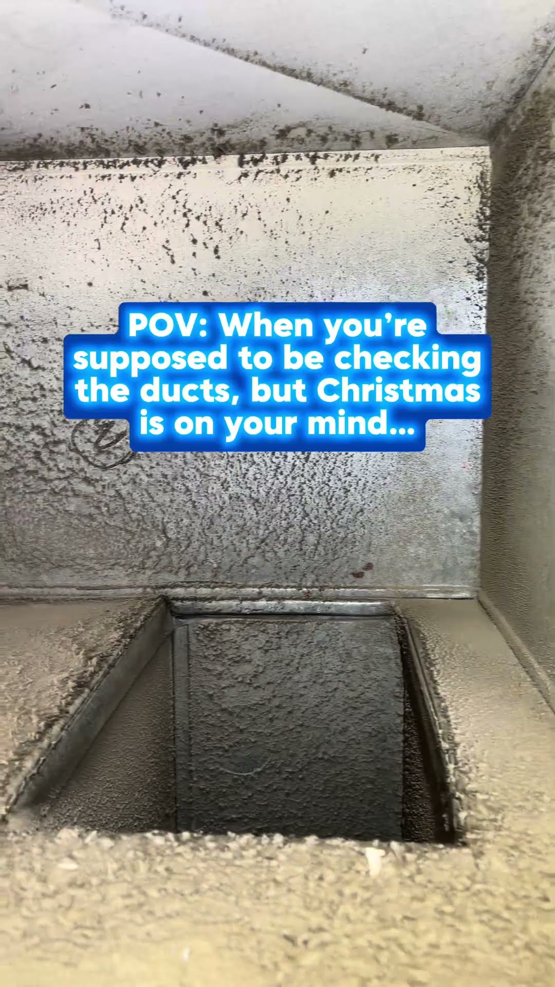 Inside a ductwork trunk and plenum coated in thick grey dust that looks like snow.